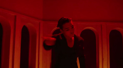 a woman standing in a room with a red light