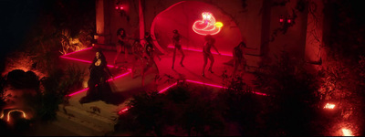 a group of mannequins standing in front of a red light