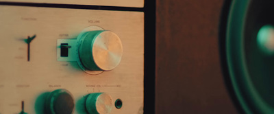 a close up of a radio with a speaker in the background