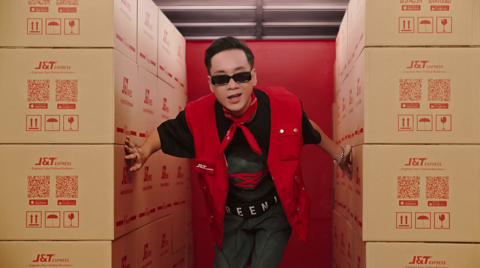 a man in a red vest and sunglasses in a red box