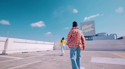 a man riding a skateboard across a parking lot