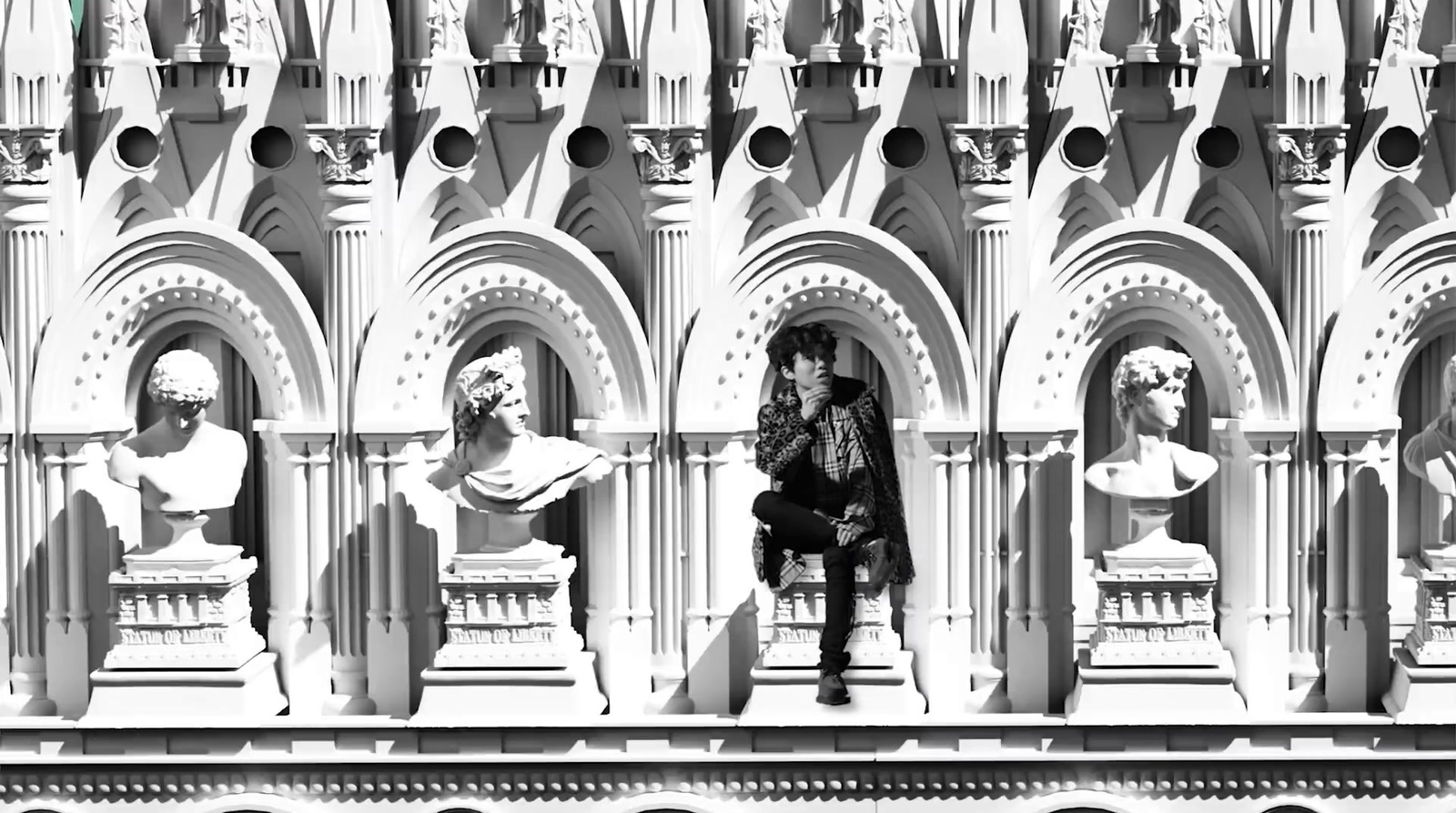 a person sitting on a bench in front of a building