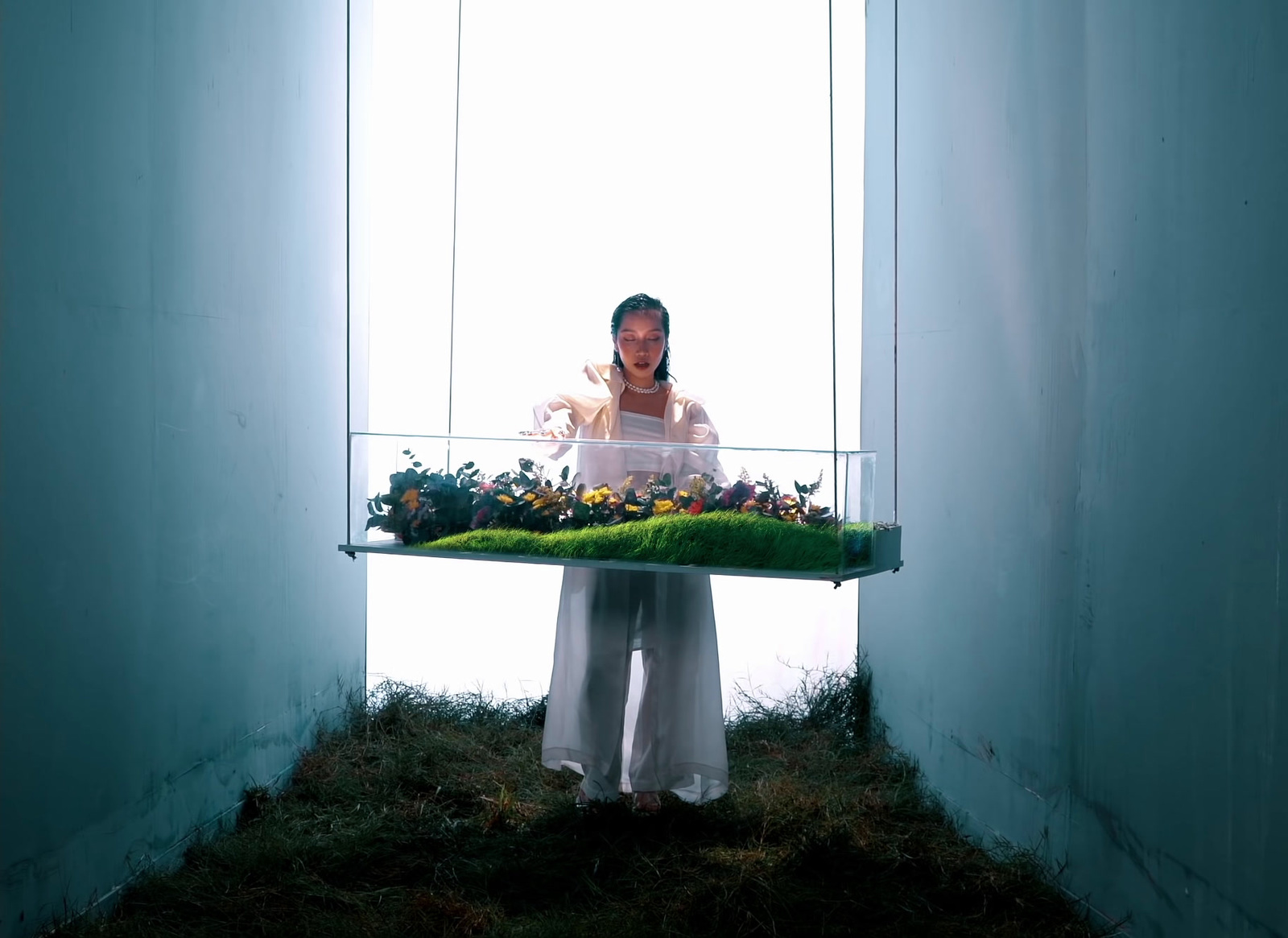 a woman holding a tray with flowers in it