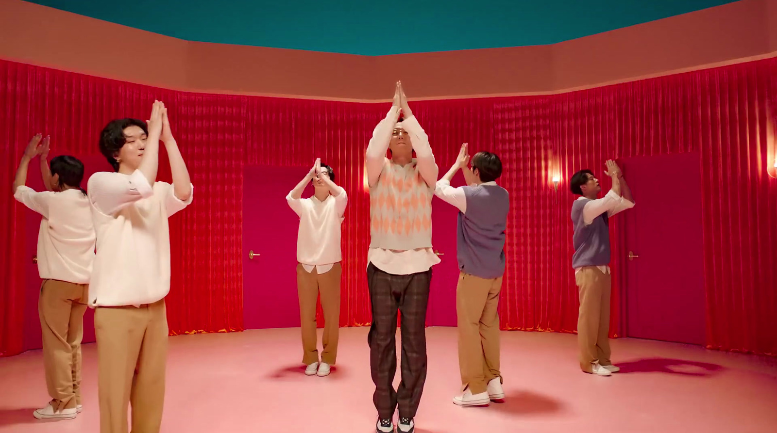 a group of people doing yoga in a room