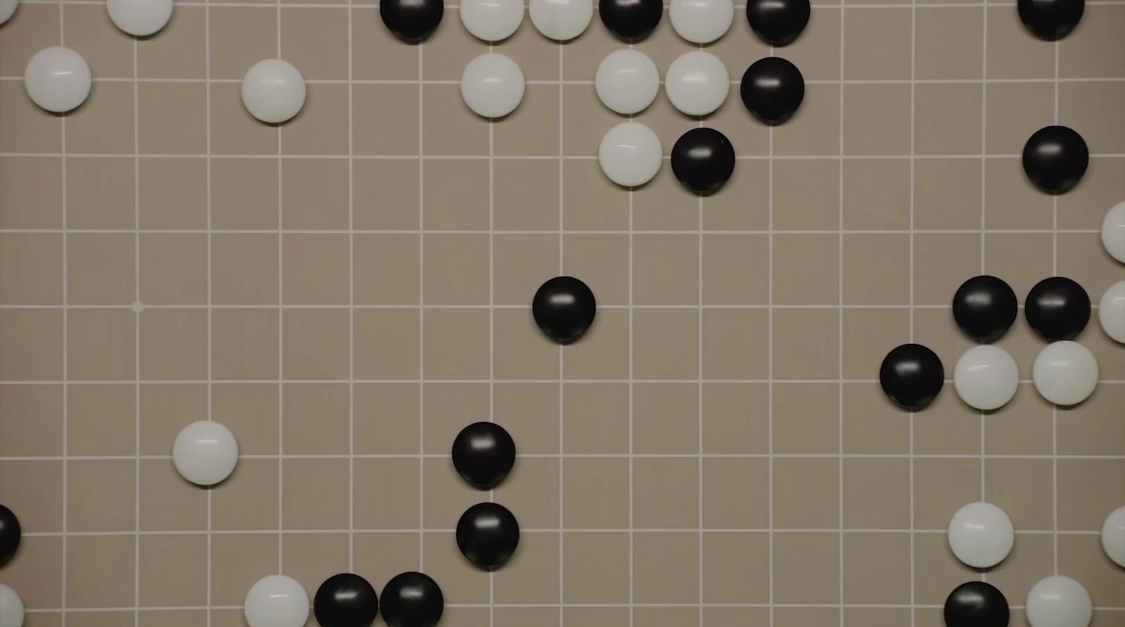 a tiled wall with black and white balls on it