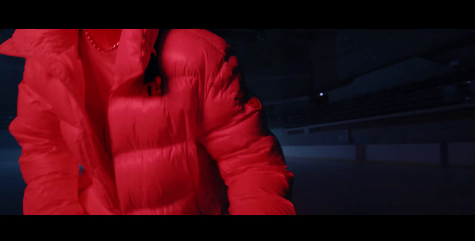 a person in a red coat in a dark room