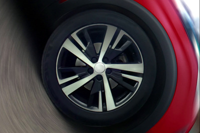 a close up of a car wheel with a blurry background