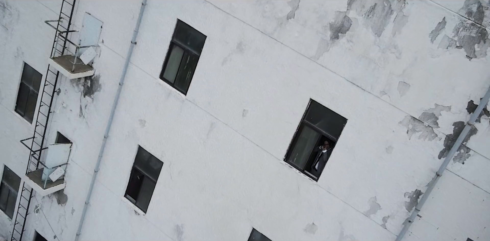 a person standing in a window of a building