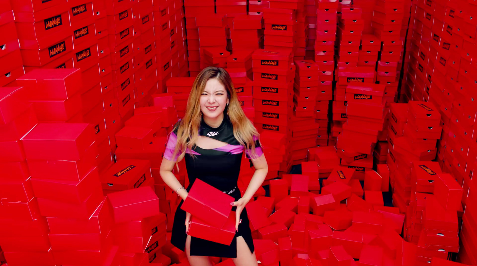 a woman standing in a room full of red boxes