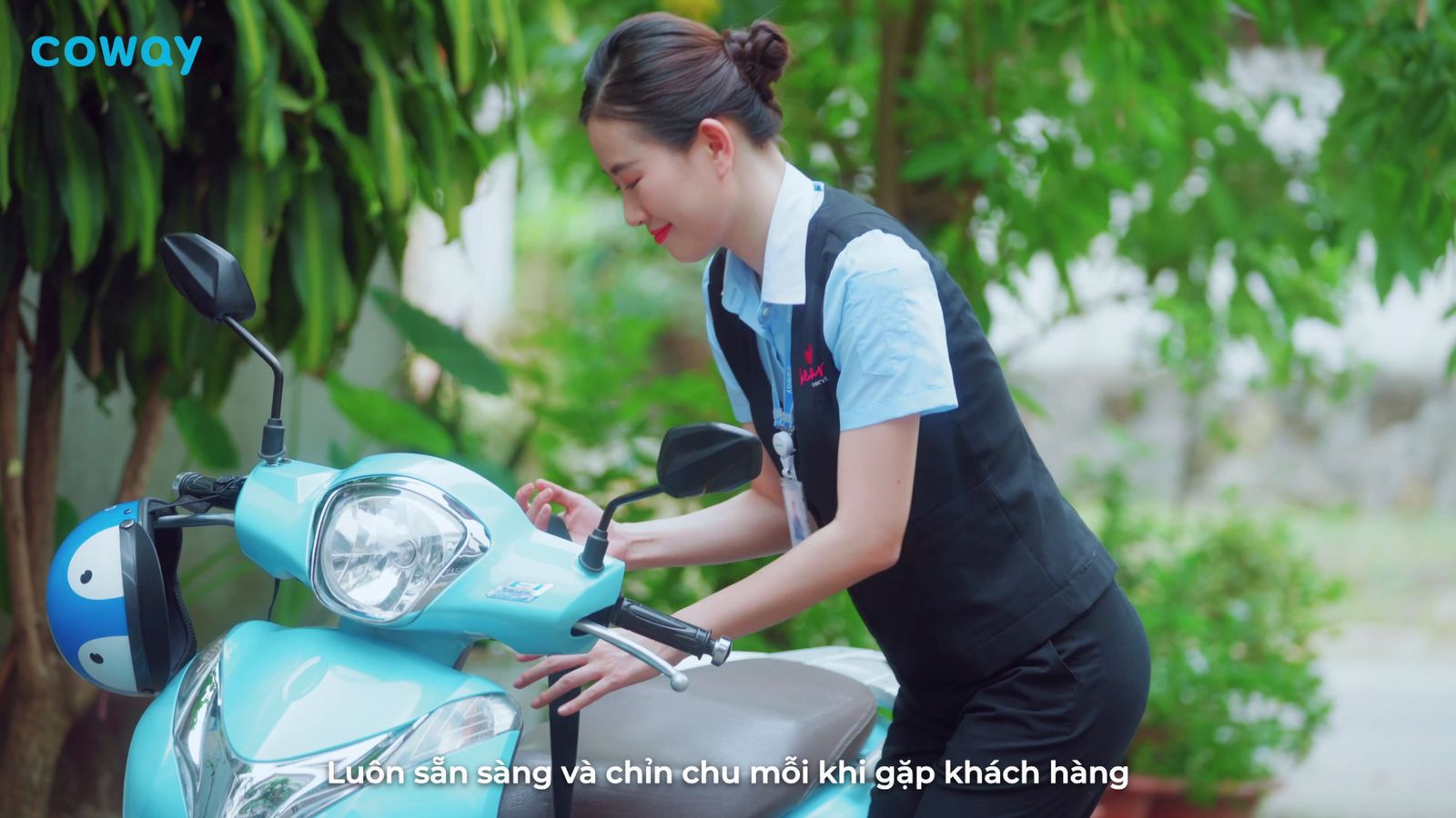 a woman in an apron is working on a blue scooter