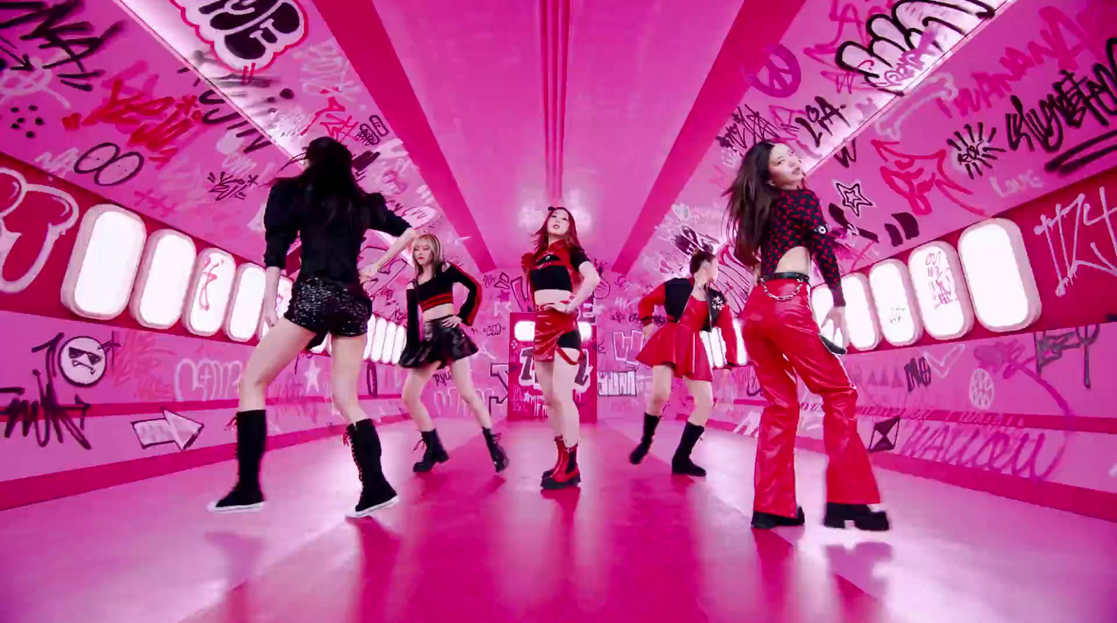 a group of women in red and black outfits