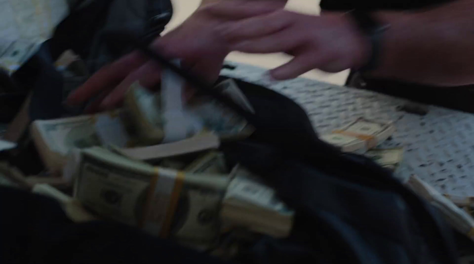 a person is putting money in a bag