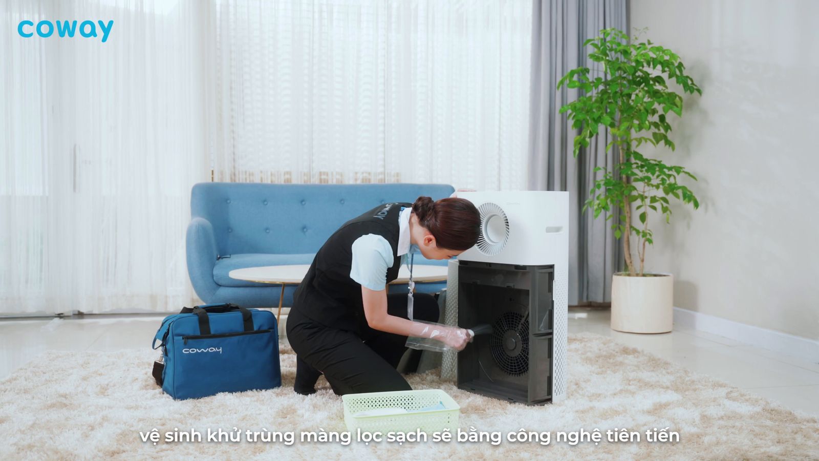 a woman kneeling down in front of a microwave oven