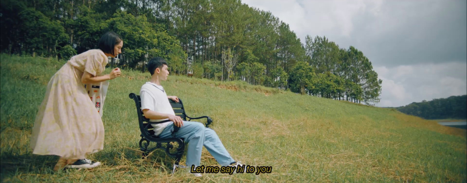 a man sitting on a bench next to a woman