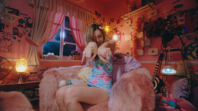 a woman sitting in a chair with a stuffed animal