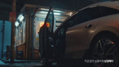 a car with its door open on a city street