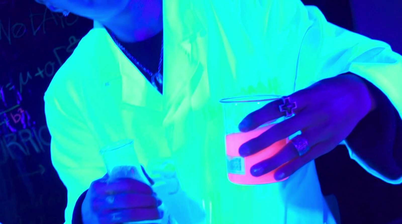 a person in a lab coat holding a glass