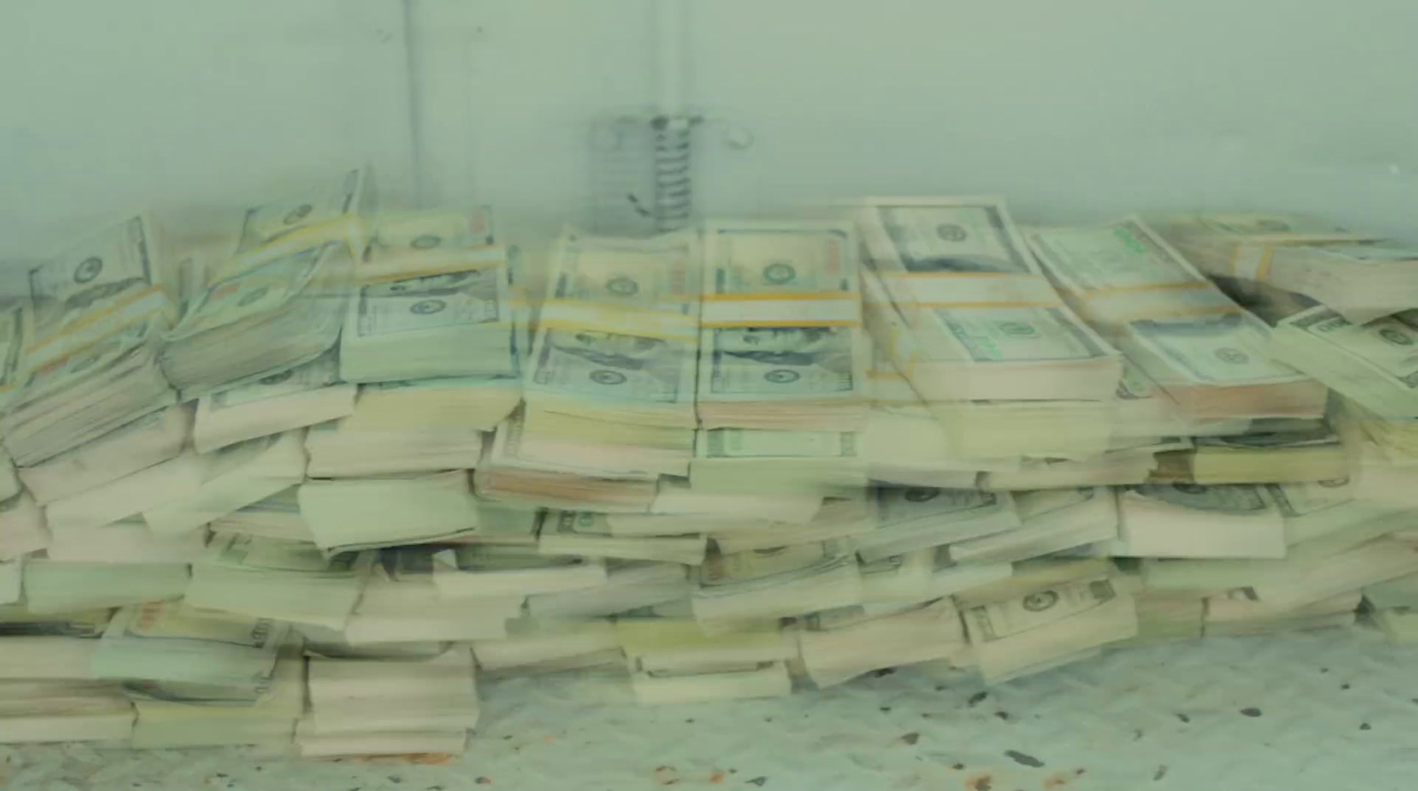 a pile of money sitting on top of a floor