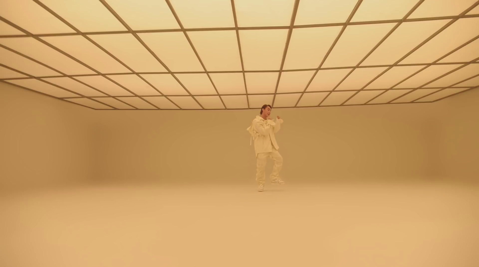 a person standing in a room with a ceiling