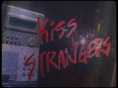 a close up of a window with the words kiss strangers written on it
