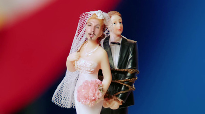 a wedding cake topper with a bride and groom