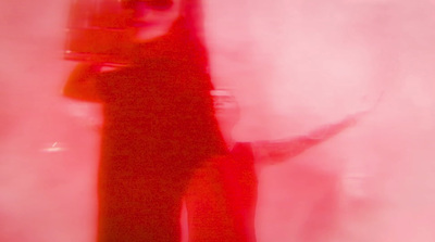 a blurry photo of a woman holding a camera