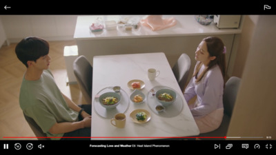 a man and a woman sitting at a table with plates of food