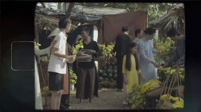 a group of people standing around a fruit stand