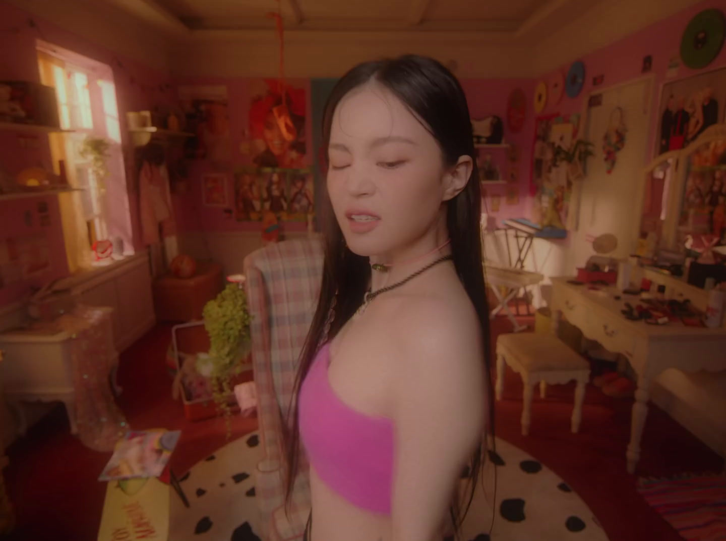 a woman in a pink top standing in a room