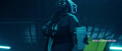 a woman in a gas mask holding a cup