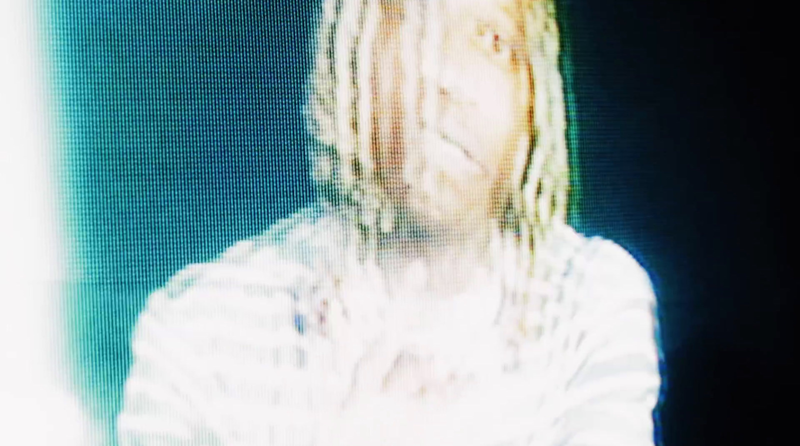 a blurry photo of a person with dreadlocks