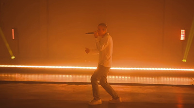 a man standing in front of a stage holding a microphone