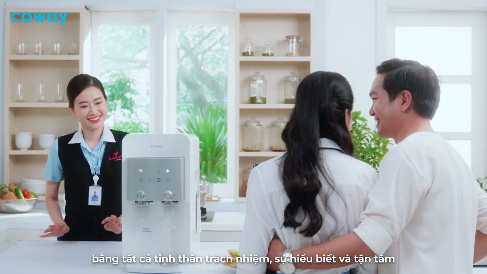 a couple of people that are standing in a kitchen