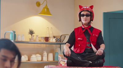 a woman sitting on top of a stool wearing a cat hat