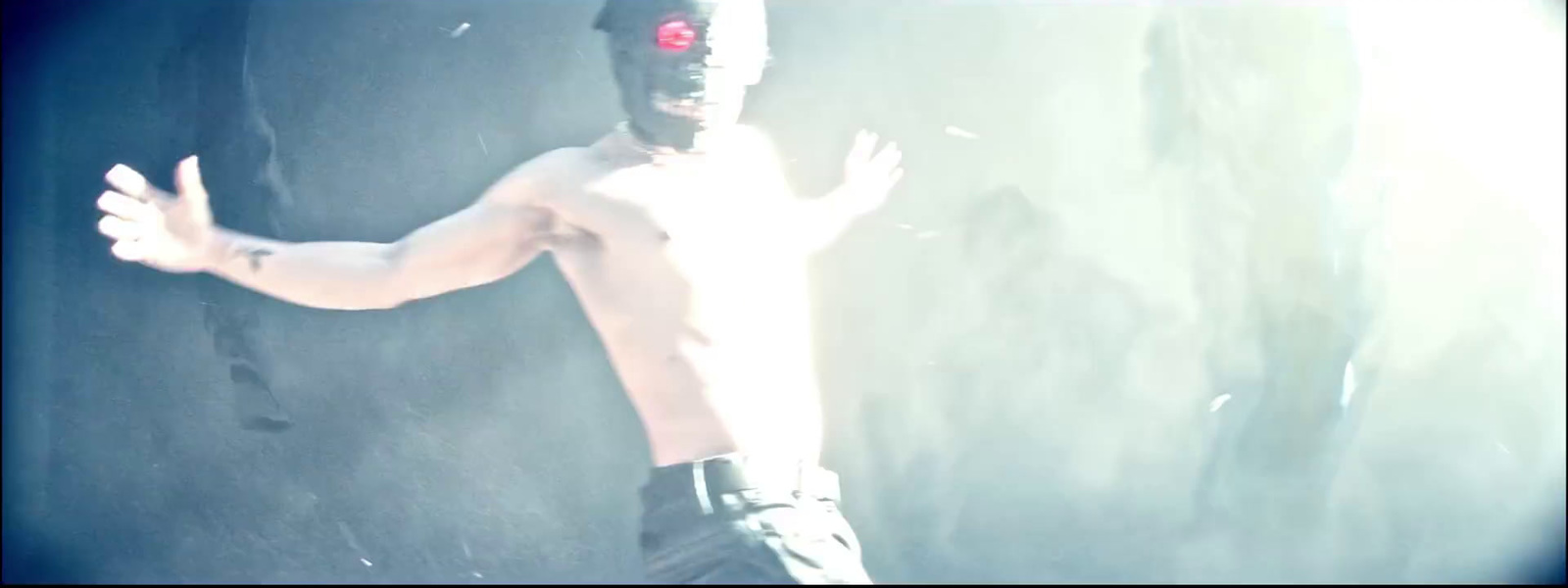 a shirtless man with a red light on his face