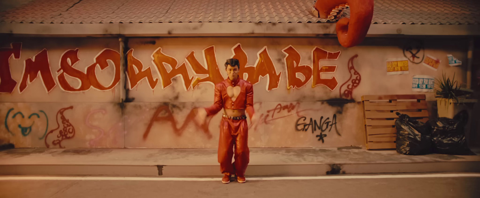 a man standing in front of a graffiti covered wall