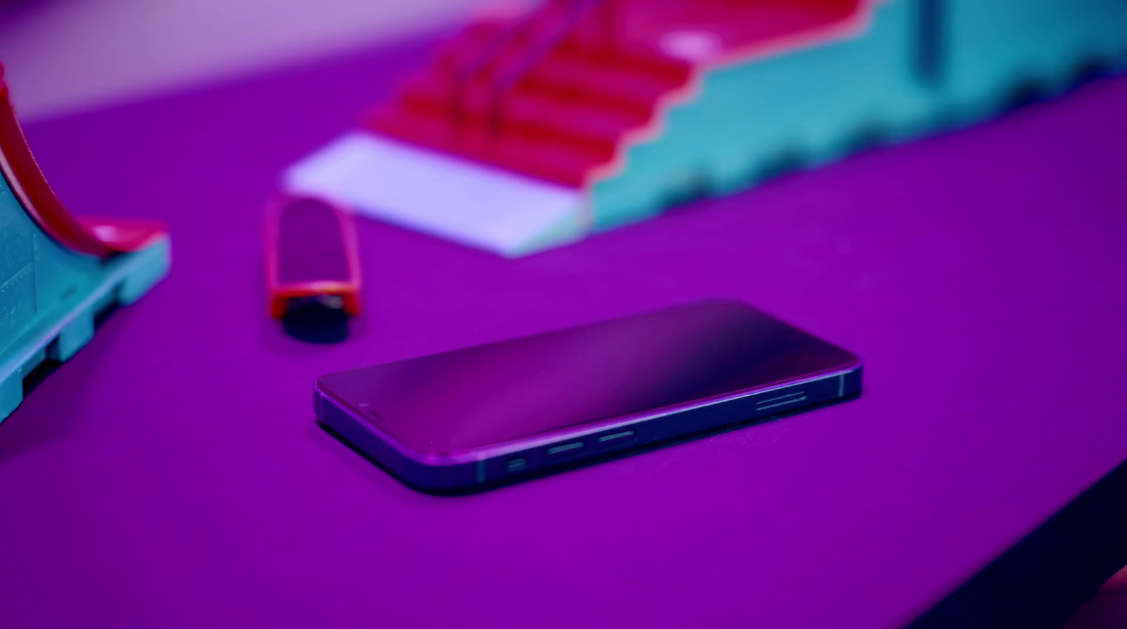 a cell phone sitting on top of a purple table