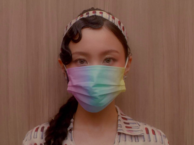 a woman wearing a colorful face mask