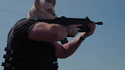 a man in a bunny mask holding a gun