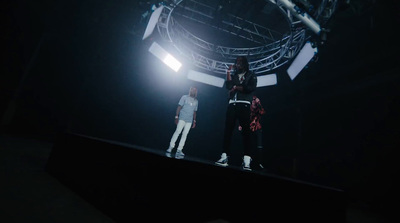 two people standing on a stage in the dark