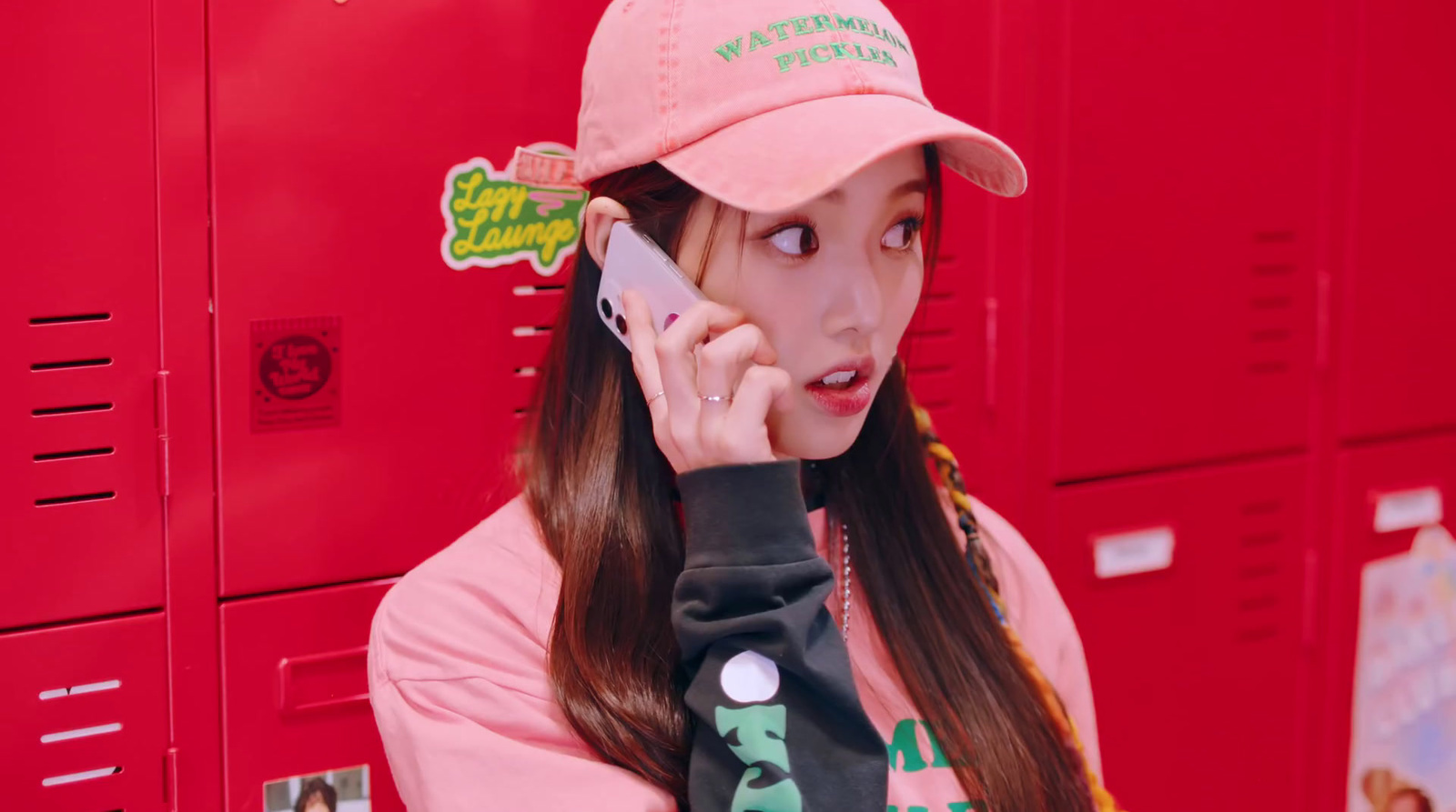 a girl in a pink hat talking on a cell phone