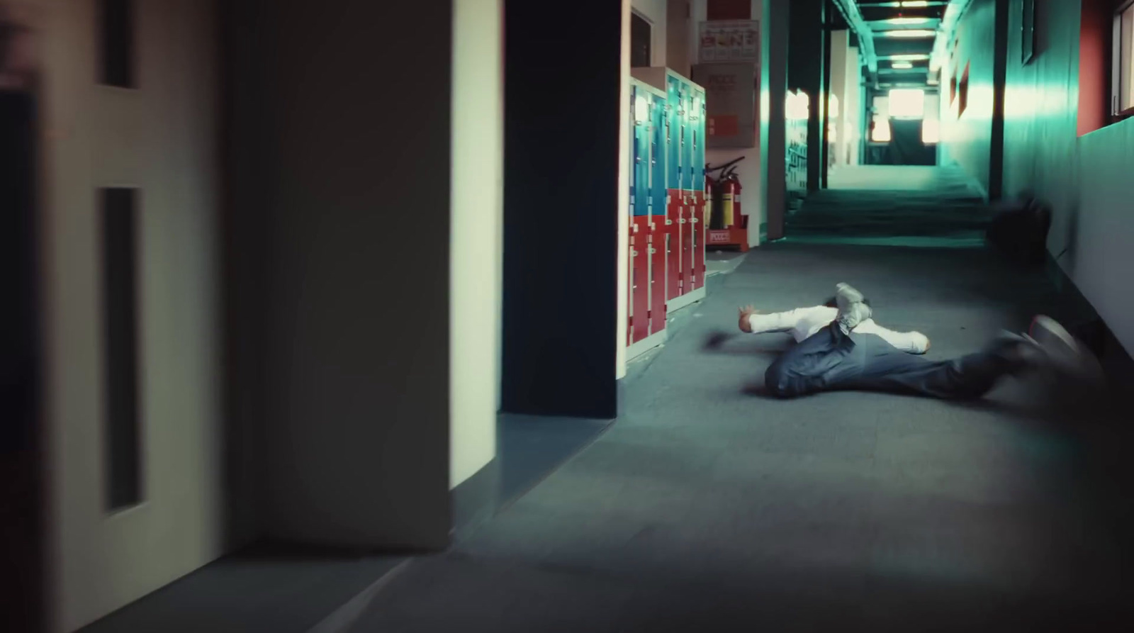 a man laying on the floor in a hallway