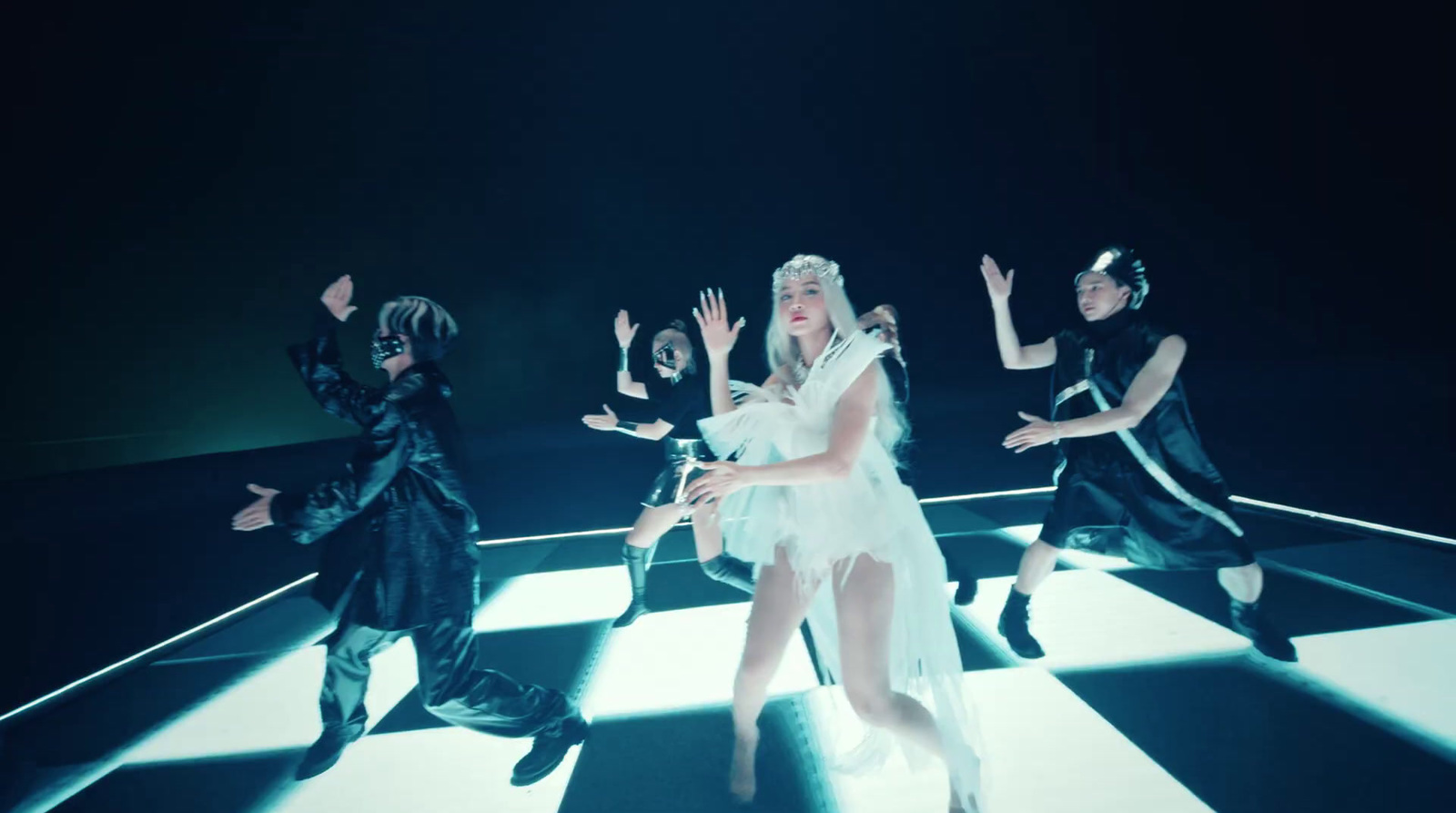 a group of people that are standing on a checkered floor