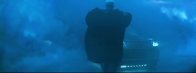 a man standing next to a car in a tunnel