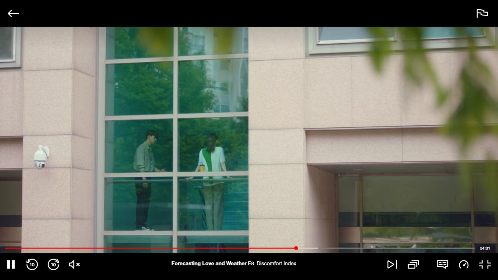 a couple of people standing outside of a building