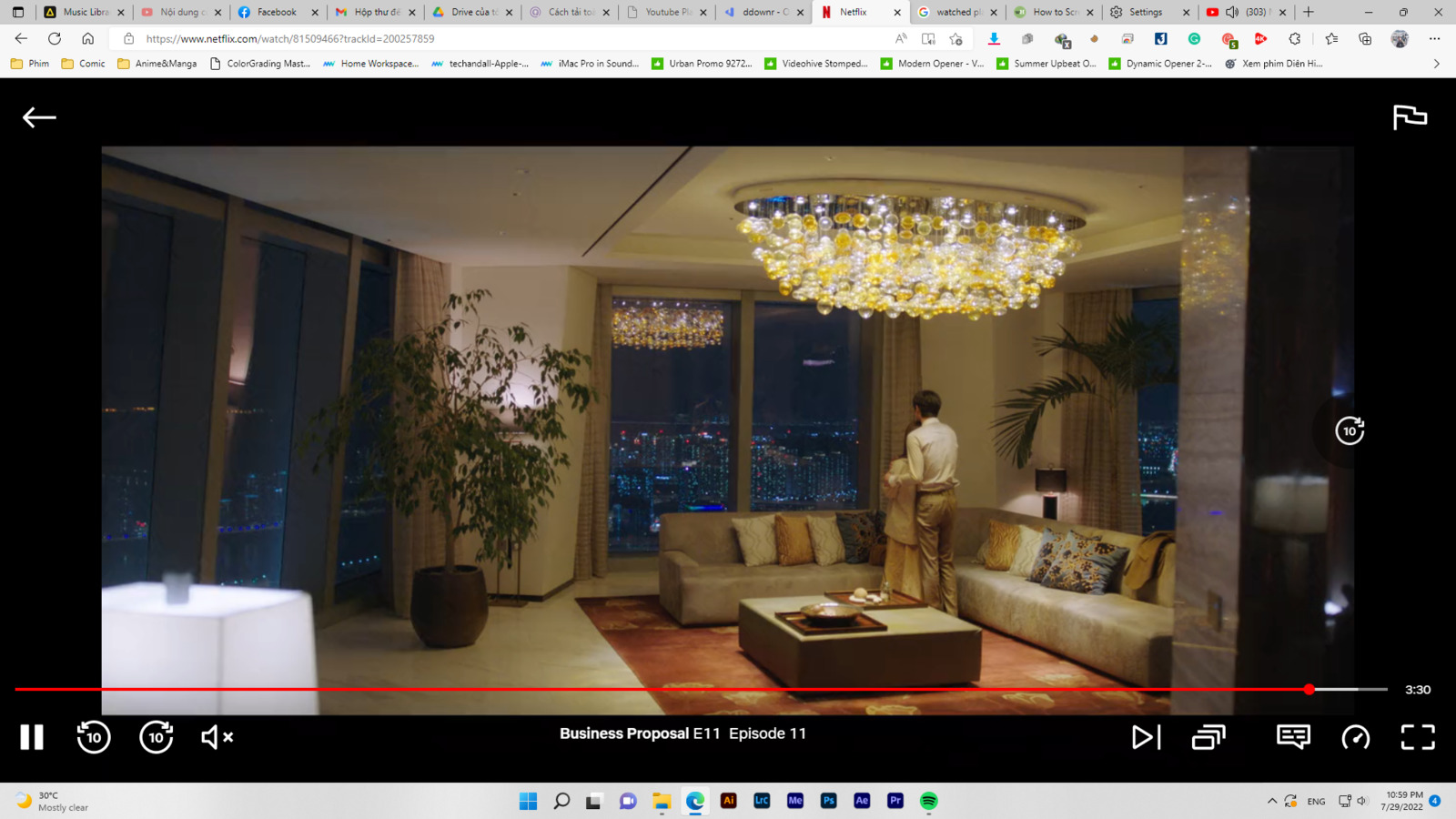 a man standing in a living room with a chandelier