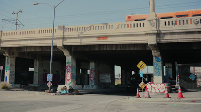 a city street with a bridge over it