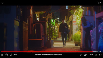 a man walking down a narrow alley way