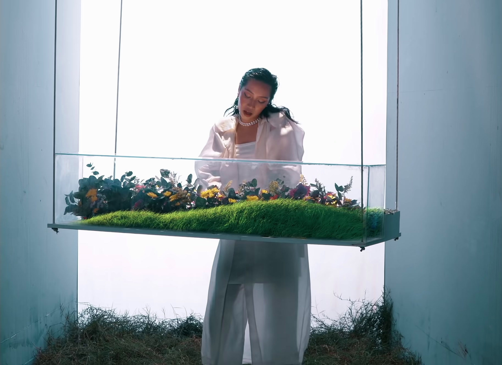 a woman standing in front of a display of flowers