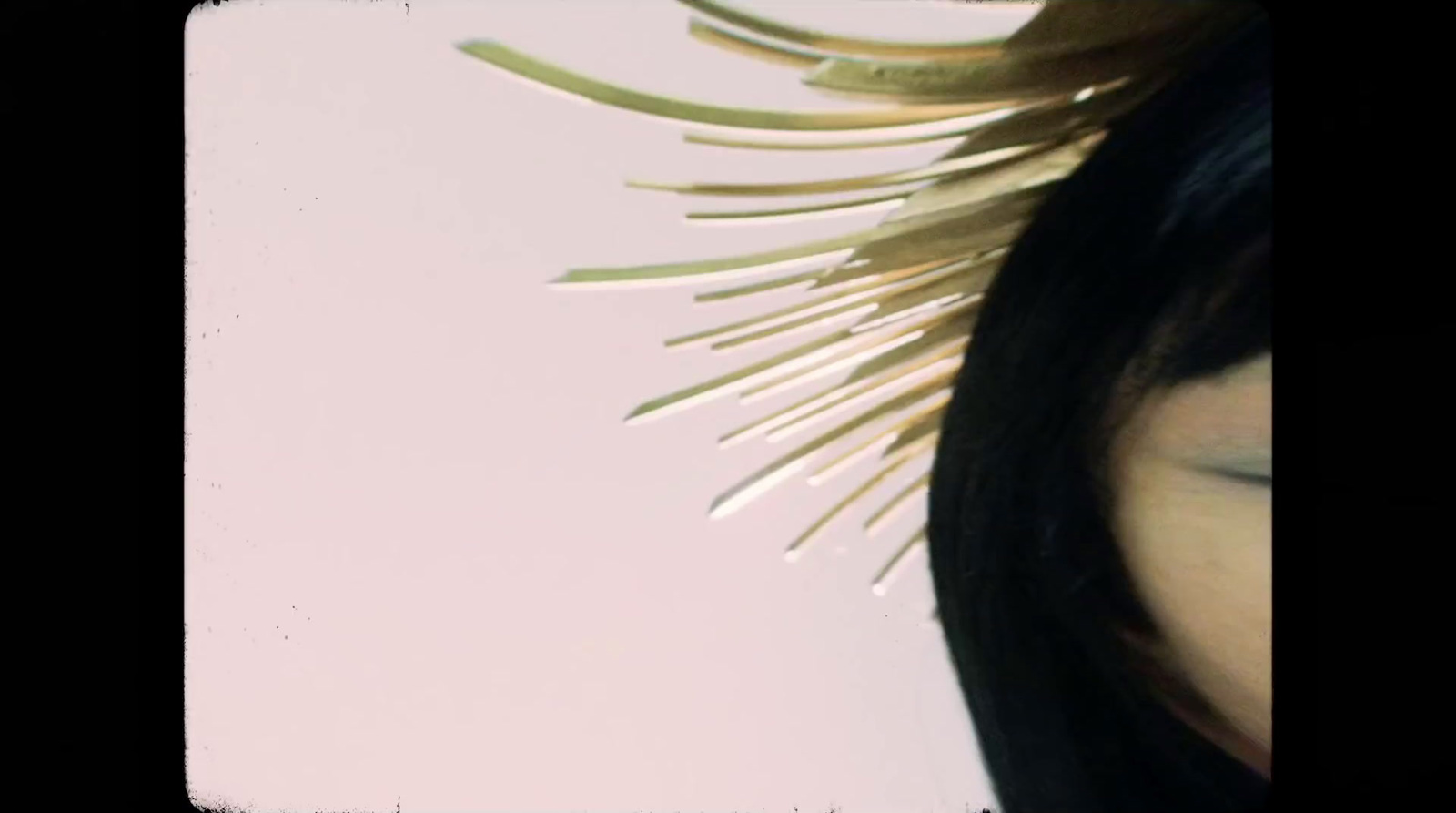 a close up of a woman's face with a hair brush in her hair